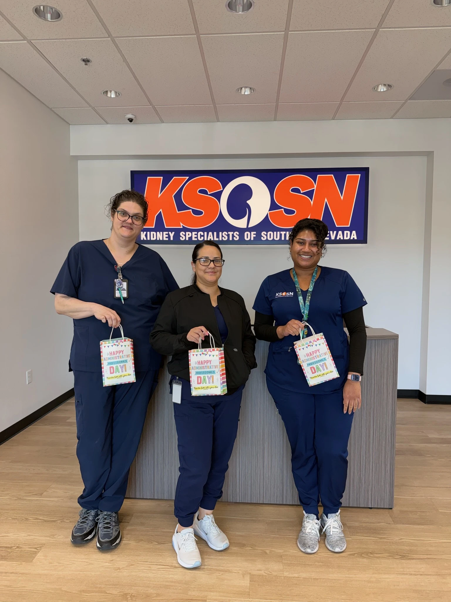 Nurses holding a gift